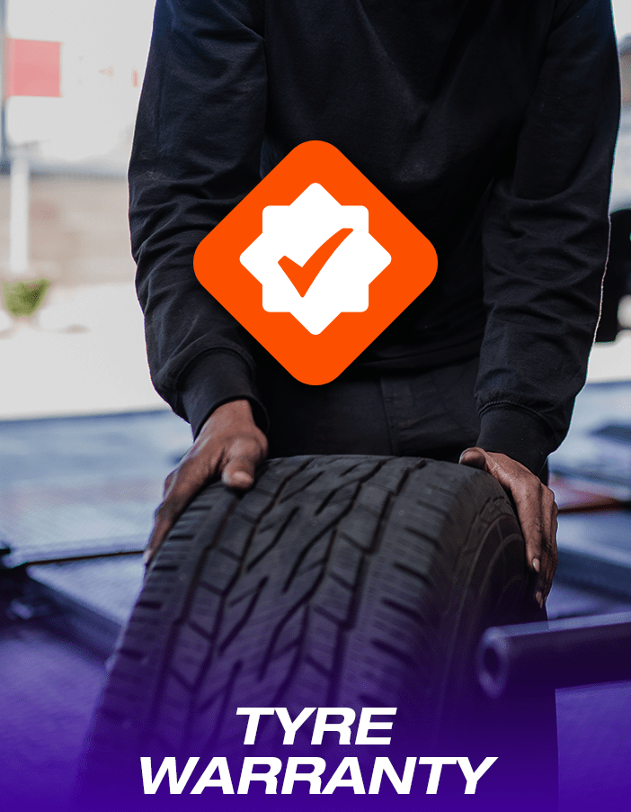Tyre Manufacturer Warranty promotion image: a technician rolling and handling a tyre.