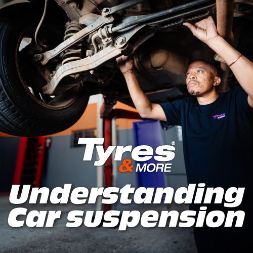 A mechanic working on car suspension